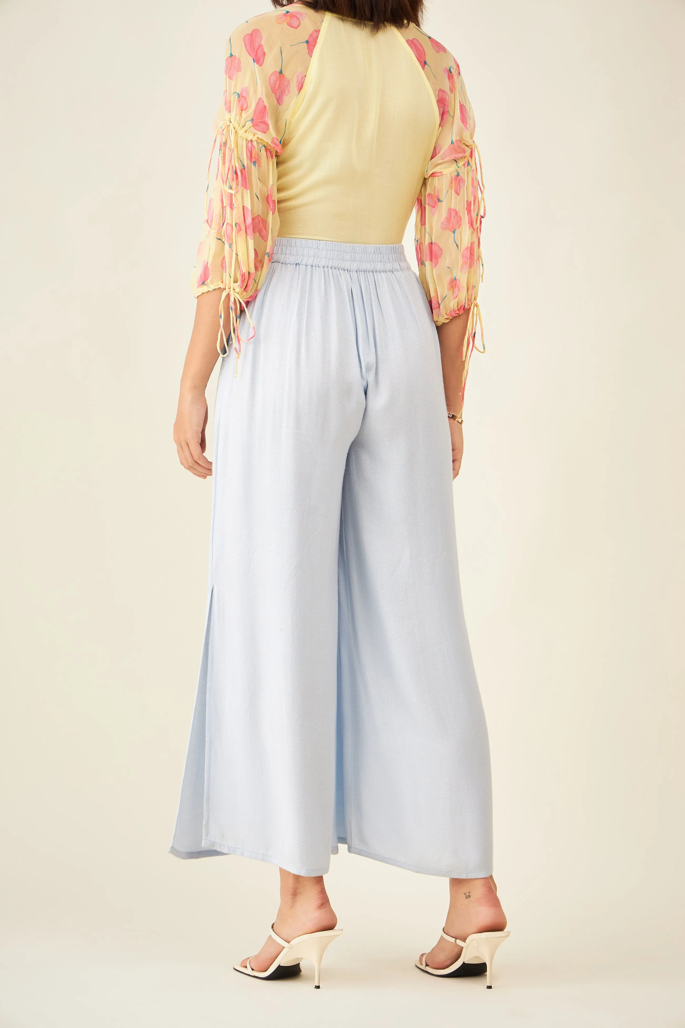 Light blue flared pants with side slit and pockets