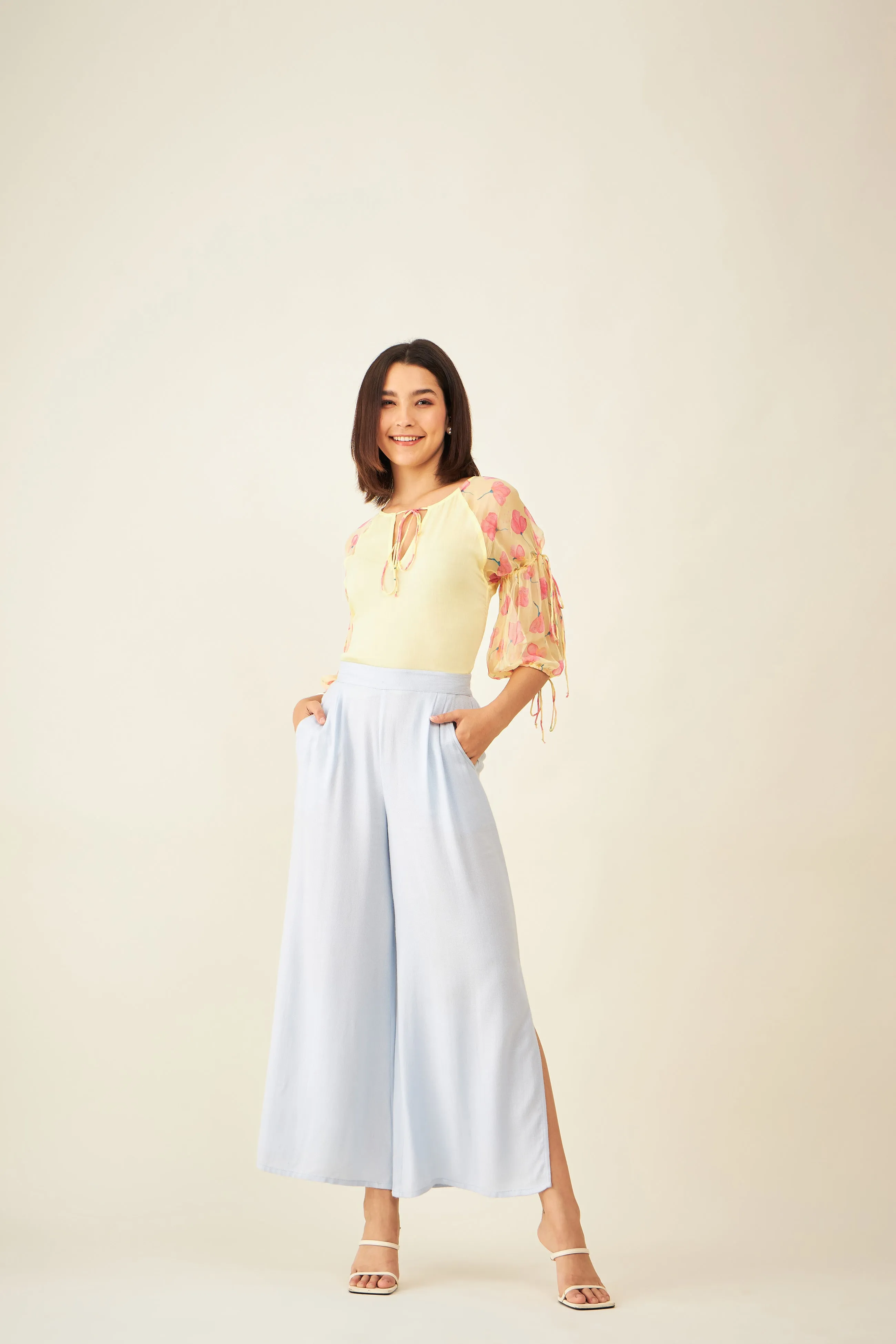 Light blue flared pants with side slit and pockets